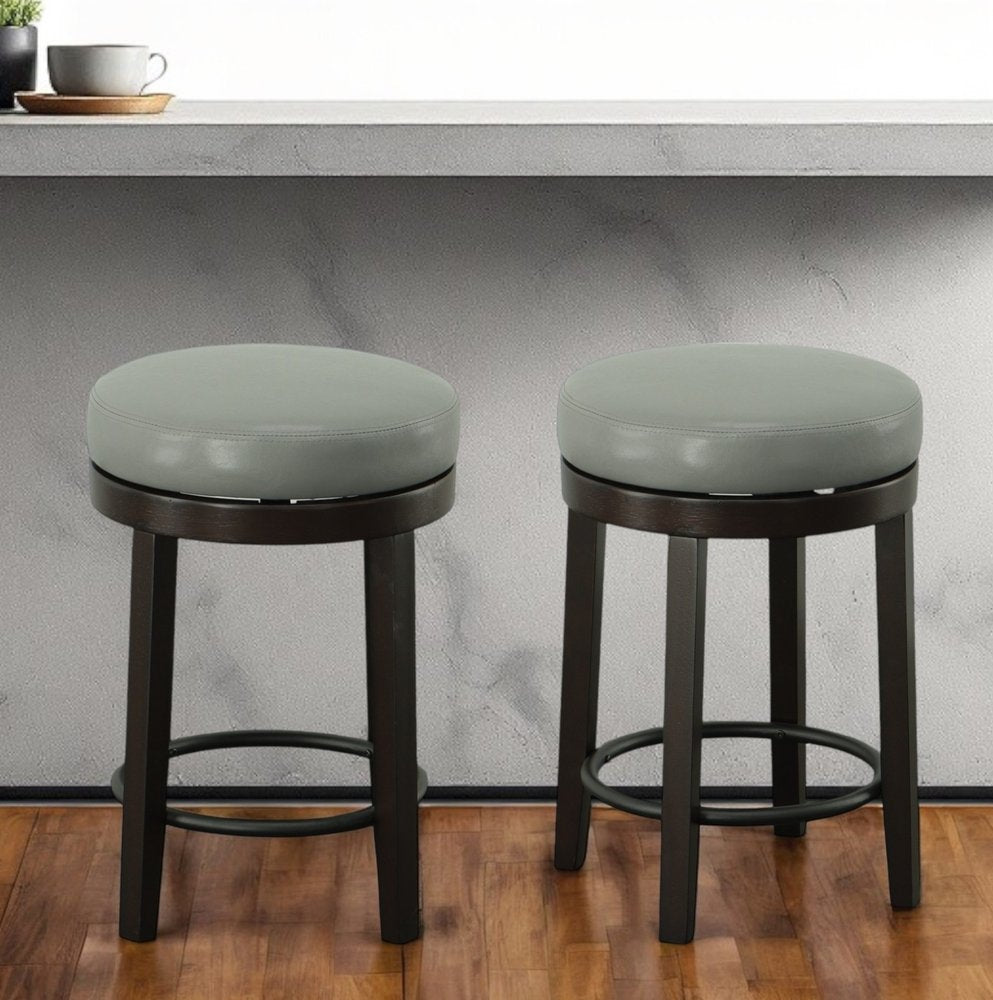 Set of Two 24 Gray and Espresso Faux Leather and Solid Wood Backless Counter Height Swivel Bar Chairs